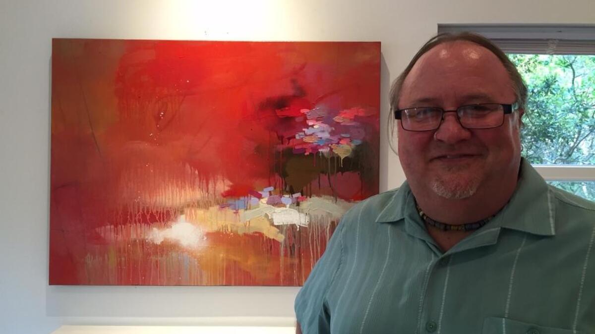Artist Todd Camp with a piece from his “Cloudscape” series.