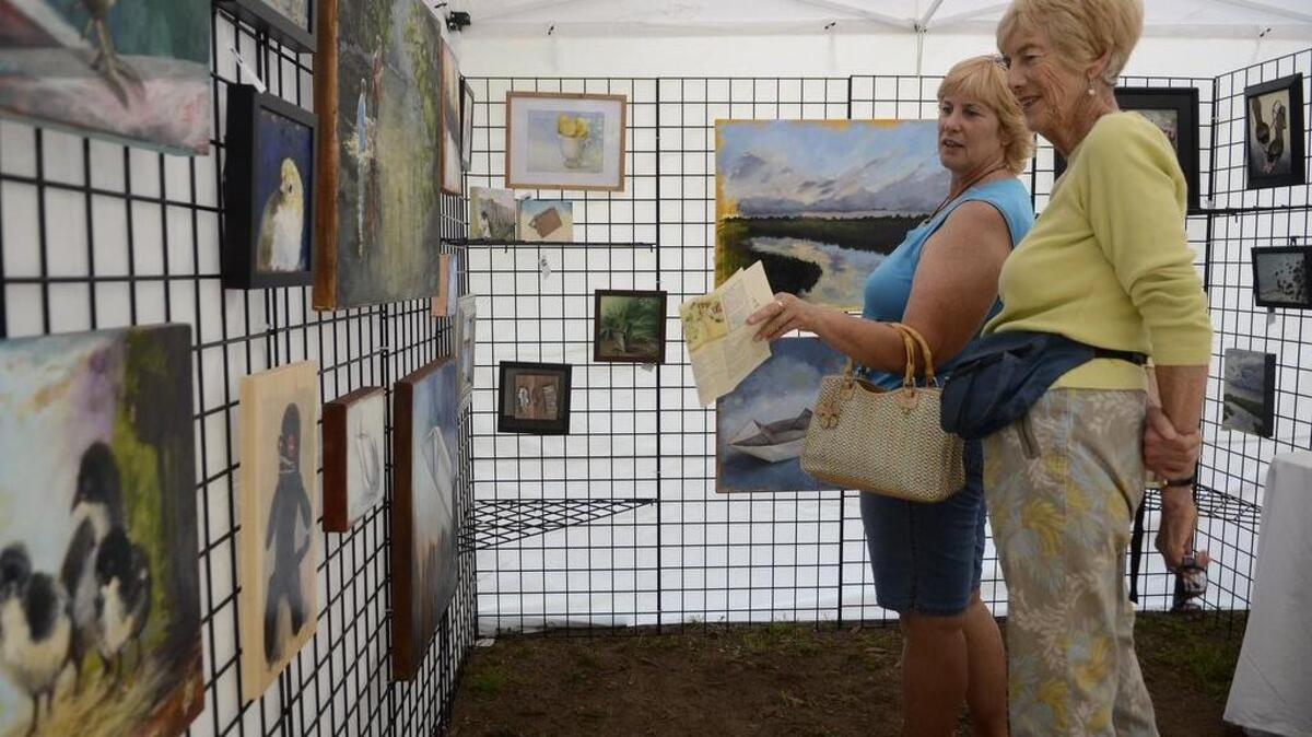 Diane Wilson, left, of St. George, Utah, and her mother Joan Wilson, of Hilton Head Island, look at artwork painted by Andie Freeman of Apex, N.C., at The Art Market last year at Historic Honey Horn on Hilton Head Island. Freeman’s work won best in show at The Art Market.