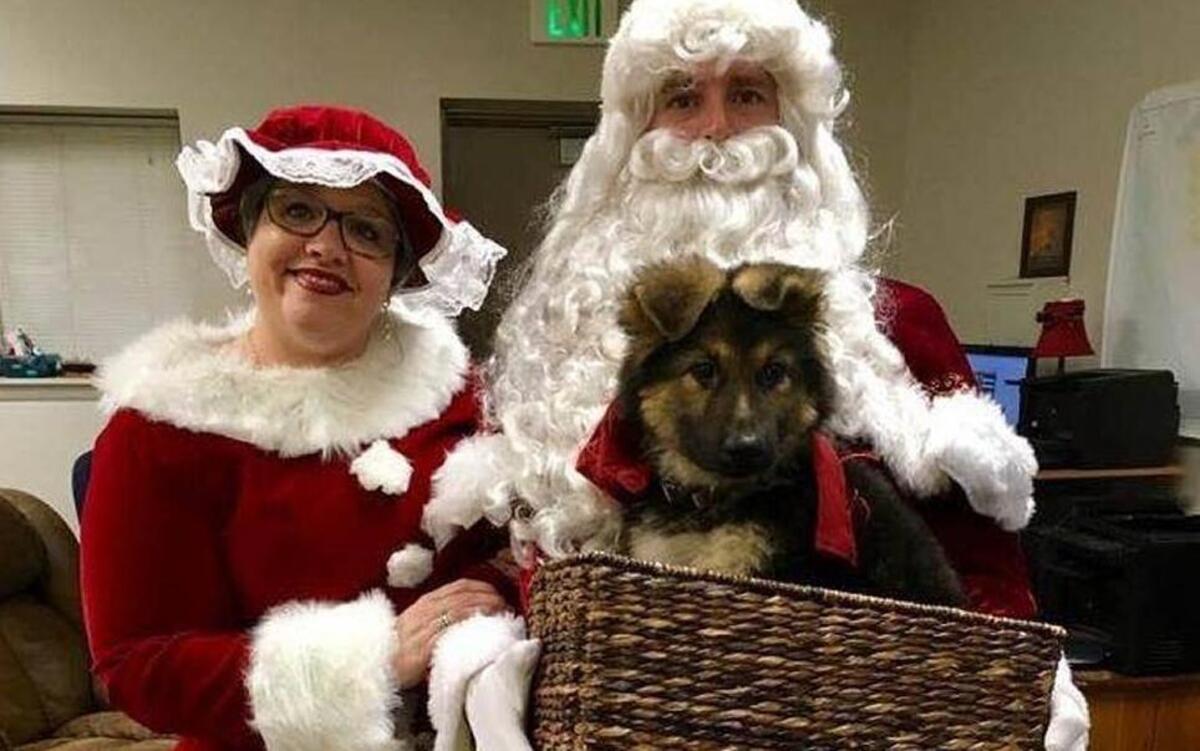 Lottie Campanella, of the Burton Fire District's assistance support team, and her husband Eric Swanson, a Burton firefighter, prepare to bring a new puppy to Bluffton Police officer Doug Armstead, who lost his dog in a house fire Dec. 2, 2016.