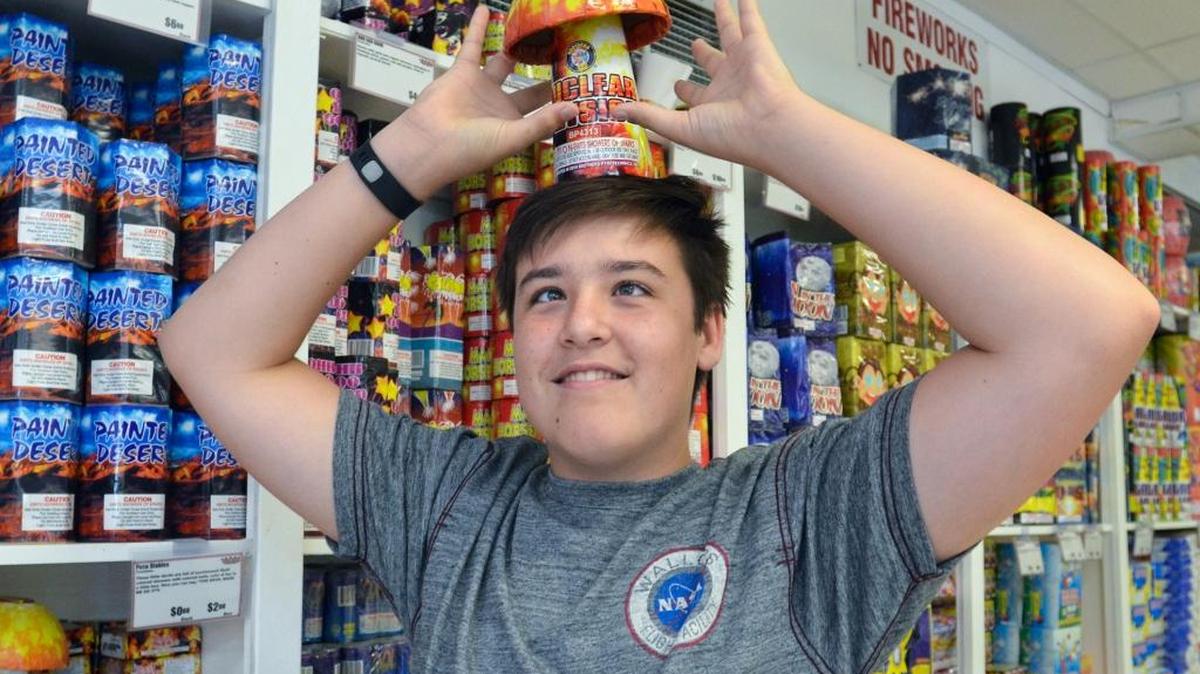 Everett Wayman, 14, of Richmond Hill, Ga., places a mushroom-shaped fireworks fountain called “Nuclear Physics” on his head while shopping with his family at the Fireworks Superstore in Hardeeville on July 1, 2016.