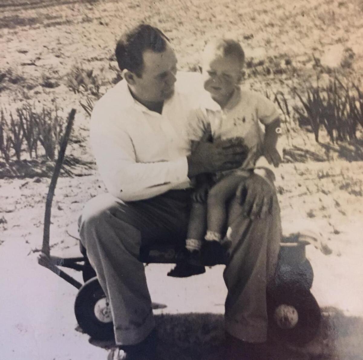 An childhood picture of my dad, Don Livingston, sitting with his father, Cecil.