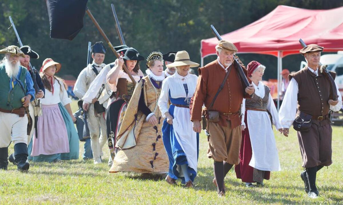 Re-enactors representing different eras of the Beaufort County’s colonial and Revolutionary War history walk in a historical parade during A Lowcountry Fair with Historical Flair in Yemassee.