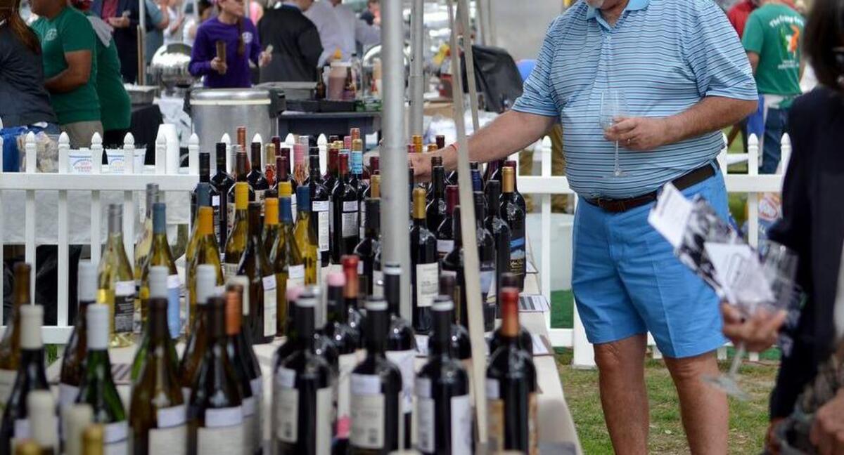 Paul Deignan, of Hilton Head Island, browses the silent auction tables one afternoon during the Hilton Head Island Food and Wine Festival at Harbour Town on Hilton Head.