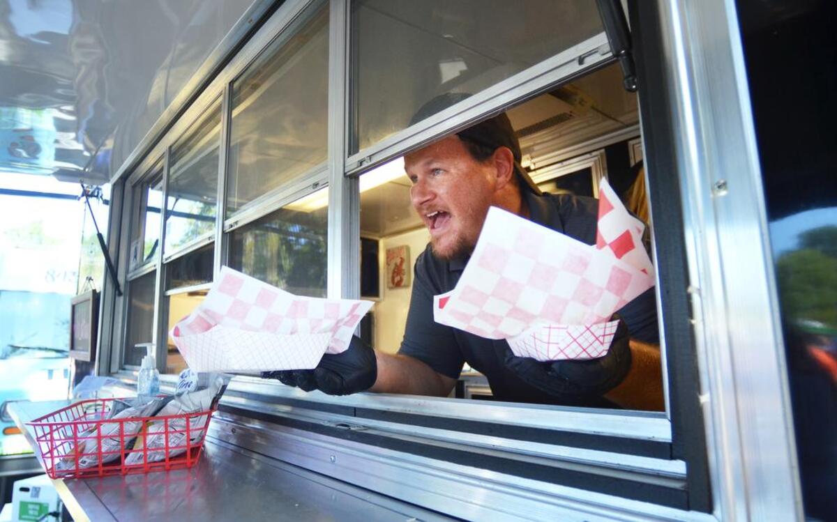 John Clark of the Lowcountry Lobstaaah food truck lets a customer know his order is ready during the inaugural Beaufort Food Truck Festival in 2017. The 2021 festival is Saturday in Port Royal.