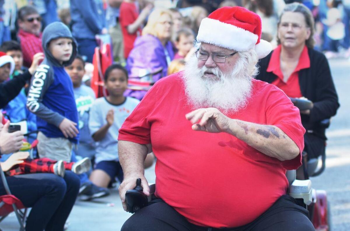 It was easy to confuse Bluffton's Jimmy Peacock with Santa Claus as he rolled down May River Road in his electric wheelchair during Saturday's parade. Though not an official part of the parade, he said he used to dress up as Santa for parties and back when he used to lead a motorcycle toy drive for Deep Well.