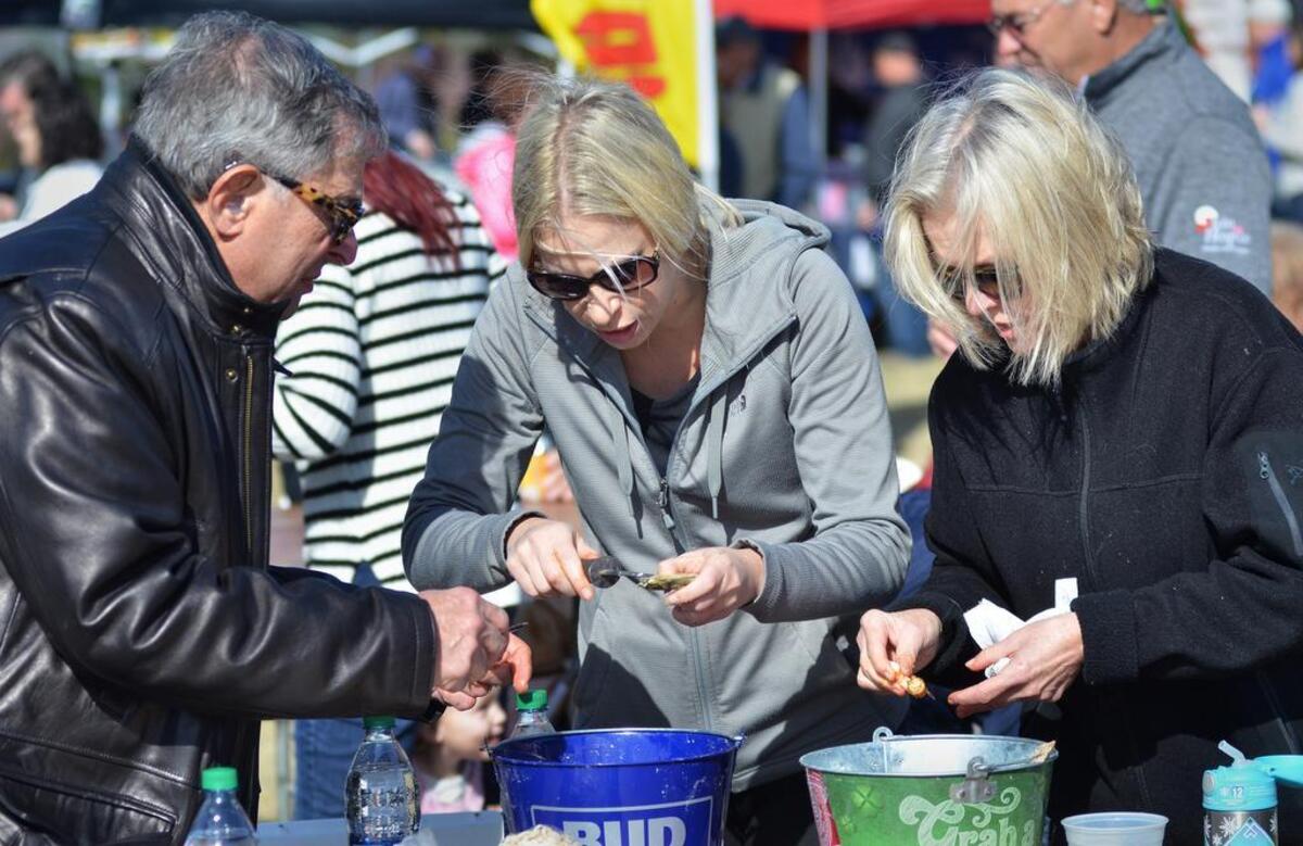 From left, part-time Hilton Head Islander Ed Eisenberg, his daughter-in-law Suzanne Eisenberg, and her mother, Jo Pichulik, both of Atlanta, dig into steamed oysters and shrimp during day two of the Hilton Head Oyster Festival at Shelter Cove Community Park in 2017.