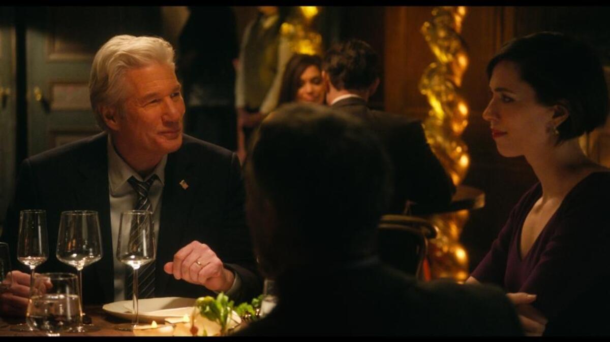 Richard Gere, left, and Rebecca Hall star in a scene from “The Dinner.”