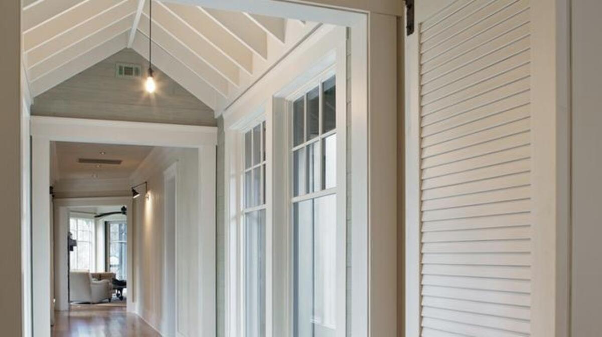 Custom-made louvered doors were hung on sliding “barn door” hardware for my clients’ home in Colleton River. This unique treatment evokes a rustic feel to the interiors and creates a point of interest in the hallway.