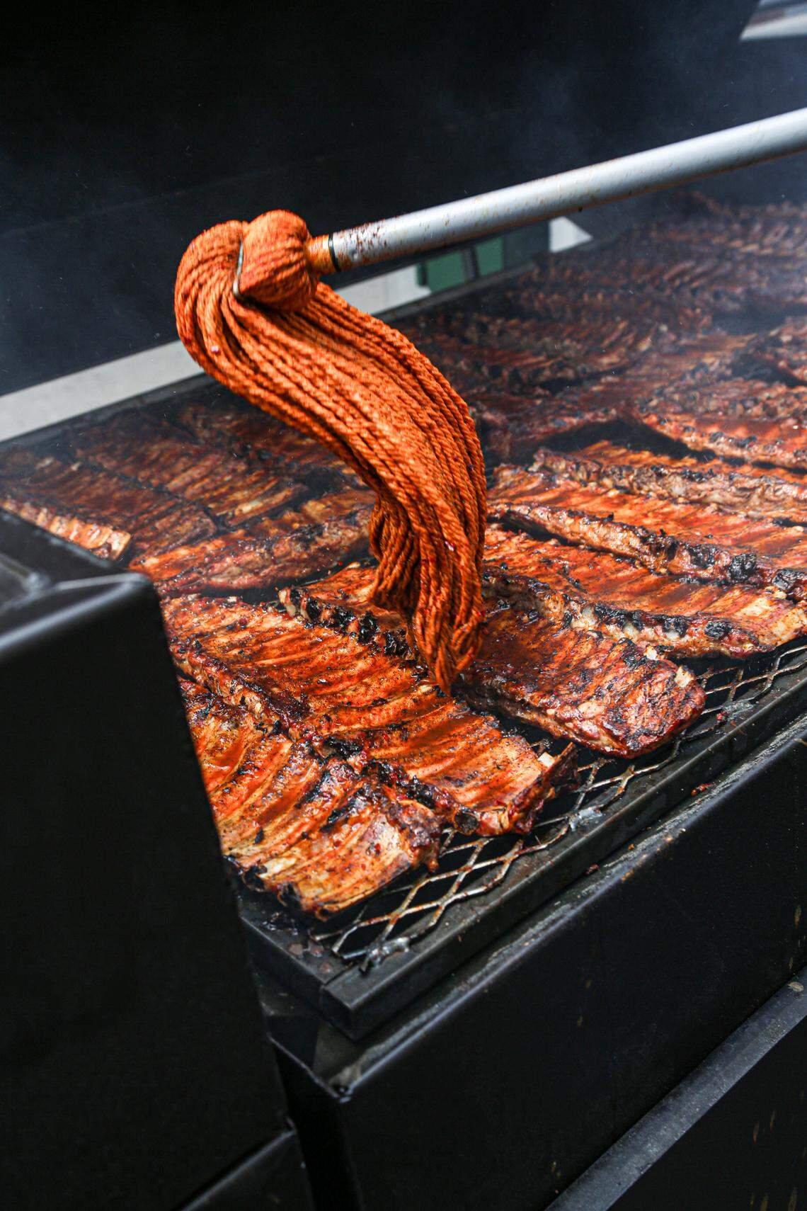 Rodney Scott’s BBQ ribs mopped in sauce as they are being prepared at the Charleston location, which can be found at 1011 King Street.