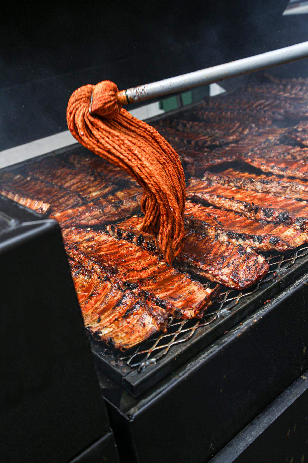 Rodney Scott’s BBQ ribs mopped in sauce as they are being prepared at the Charleston location, which can be found at 1011 King Street.