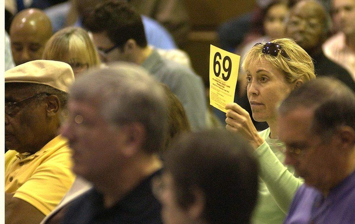 A woman bids on one of the 1,572 properties during the annual delinquent tax sale auction in 2012 at the Charles Lind Brown Activity Center in Beaufort.