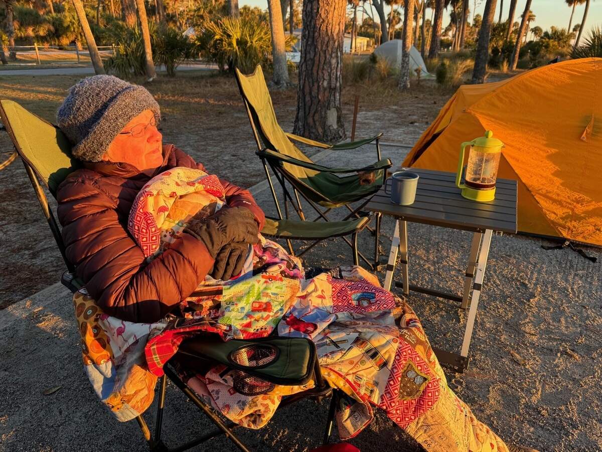 Terry Swanson warms herself in the sun Wednesday morning at Hunting Island State Park campground. Swanson and her husband, David, arrived Tuesday evening. When they woke up Wednesday morning, it was 33 degrees. “We had frost,” David said.