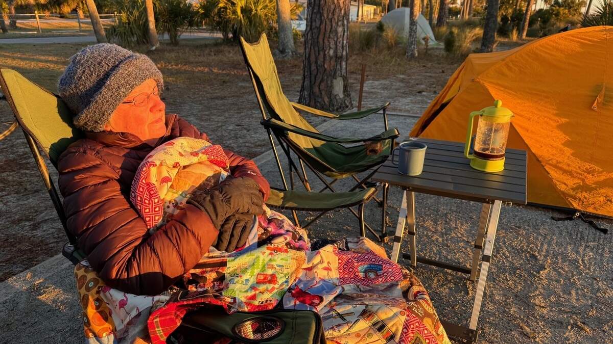 Terry Swanson warms herself in the sun Wednesday morning at Hunting Island State Park campground. Swanson and her husband, David, arrived Tuesday evening. When they woke up Wednesday morning, it was 33 degrees. “We had frost,” David said.
