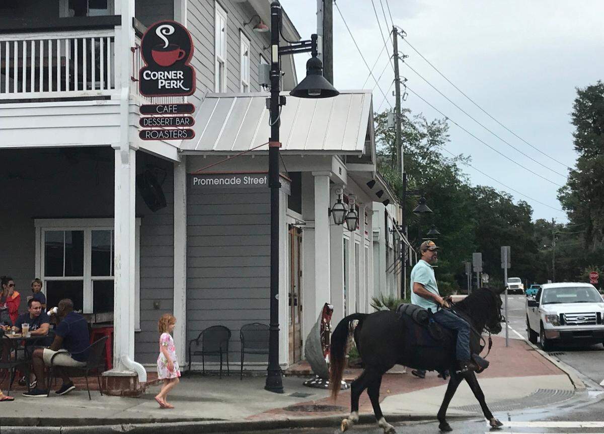 An unknown man on a horse rides through Old Town Bluffton on Wednesday afternoon.