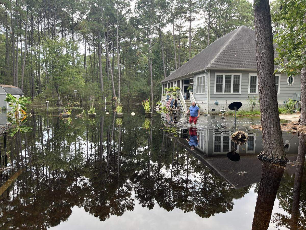 Mark Presnell wades through 2 feet of water in his driveway. Water has refused to go down for more than a month. He blames Beaufort County and the South Carolina Department of Transportation.