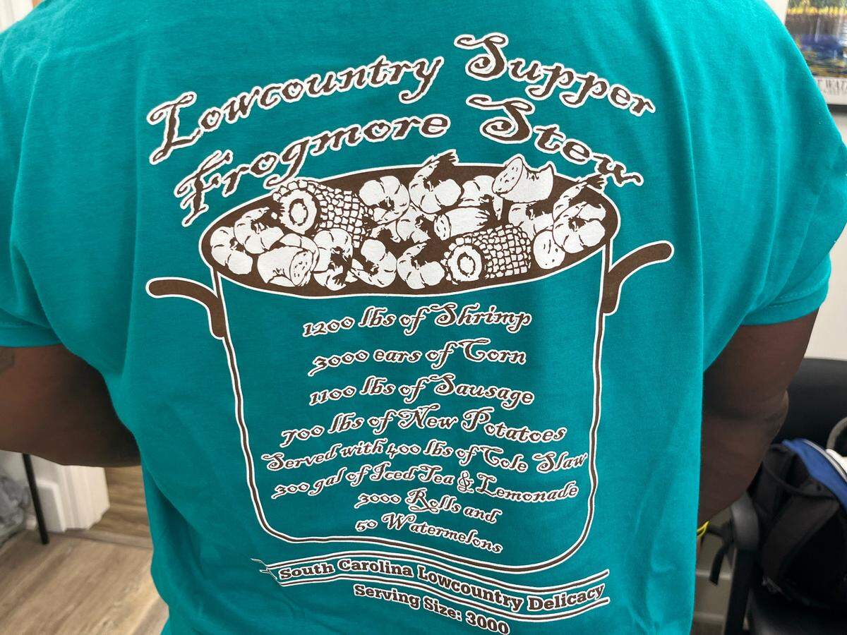 Greg Godfrey, a spokesman for the Beaufort Water Festival, displays the back of his T-shirt that shows the amounts of food served during Thursday’s Lowcountry Supper.