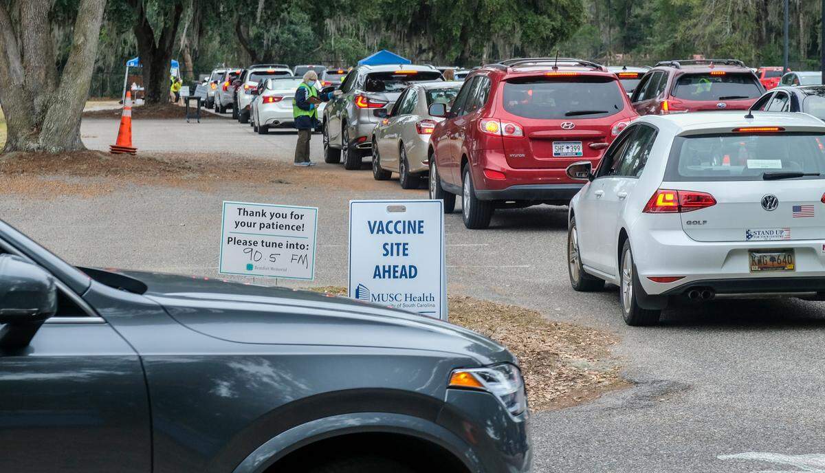 Cars move into lines on Thursday, Jan. 21, 2021 at Beaufort Memorial Hospital’s drive-thru clinic for the Pfizer-BioNTech’s vaccine in the parking lot at Beaufort High School’s stadium. In the first hour and a half hospital staff vaccinated 250 people, according to Deidre Robinson in the hospital’s communications department.