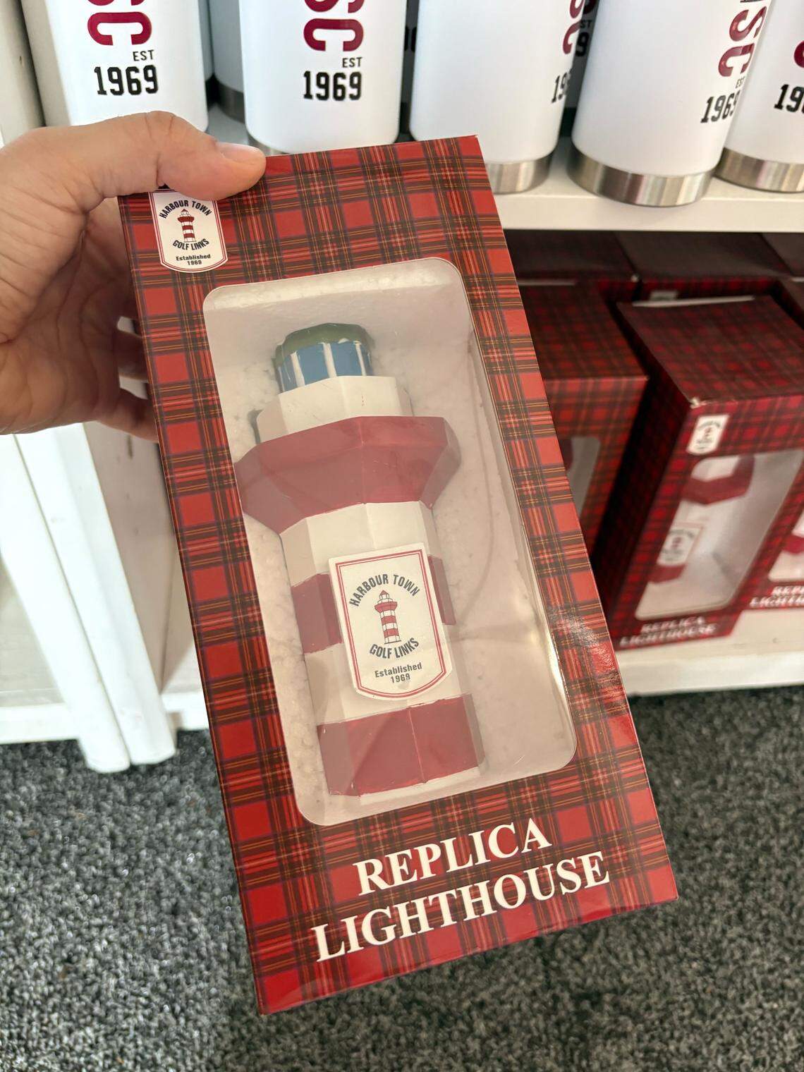 Small replicas of the Harbour Town lighthouse are for sale at the Peter Millar Merchandise Tent at RBC Heritage on Hilton Head Island in 2026.