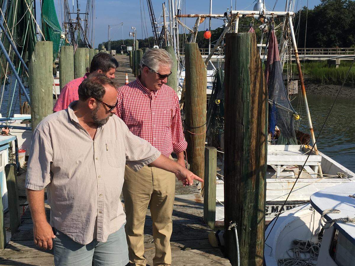 In this file photo, Grey Ghost Properties developer Whit Suber, from front, Port Royal Town Manager Van Willis and Councilman Jerry Ashmore survey the town’s shrimp dock on Aug. 7, 2019. Town officials planned to clear out abandoned boats and vessels not actively shrimping after one of the boats at the dock sank that week.
