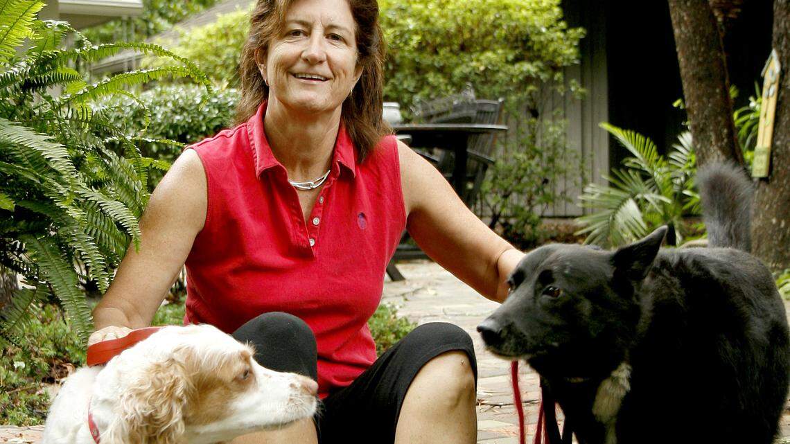 Hilton Head Island resident, Tamra Shattuck, formerly of Bluffton is photographed with Lilly, left, and her dog Holly house-sitting at a friends house in Hilton Head Plantation on Hilton Head Island Thursday afternoon. On Wednesday, the trio went out for a walk around the lagoon surrounded by homes when an 8-foot female alligator sprang from the lagoon and bit her right foot.