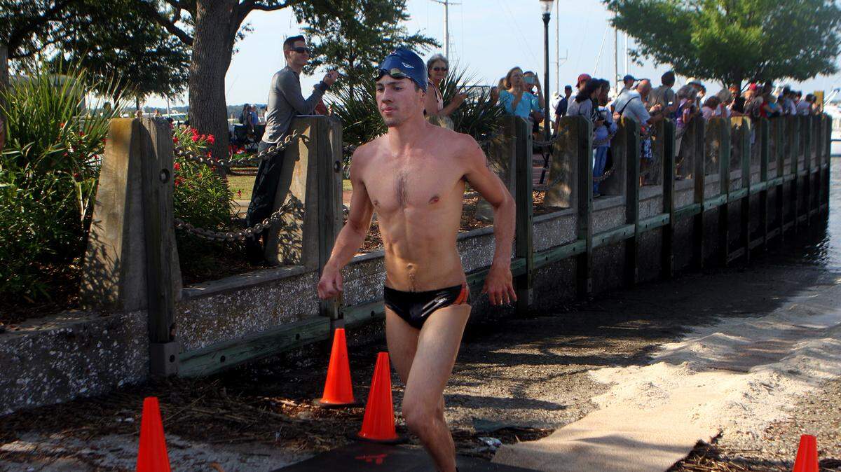 James Hammond of Hilton Head Island crosses the finish line at the end of the 9th Annual Beaufort River Swim on Saturday morning at the Downtown Marina of Beaufort in Beaufort.  Hammond placed first overall.