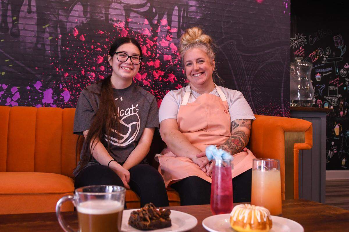 Erica Ashby, right, poses for a photo with her daughter Kaiya, on Aug. 16, 2023, at their store Cupcakes 2 Cakes in Berkeley Place in Bluffton. Ashby plans to offer mocktails paired with desserts for after-movie or after-dinner treats. Pictured from left is a bourbon coffee, rockslide brownie, cotton candy lemonade and a piña colada with a lemon glazed bundt cake in front.