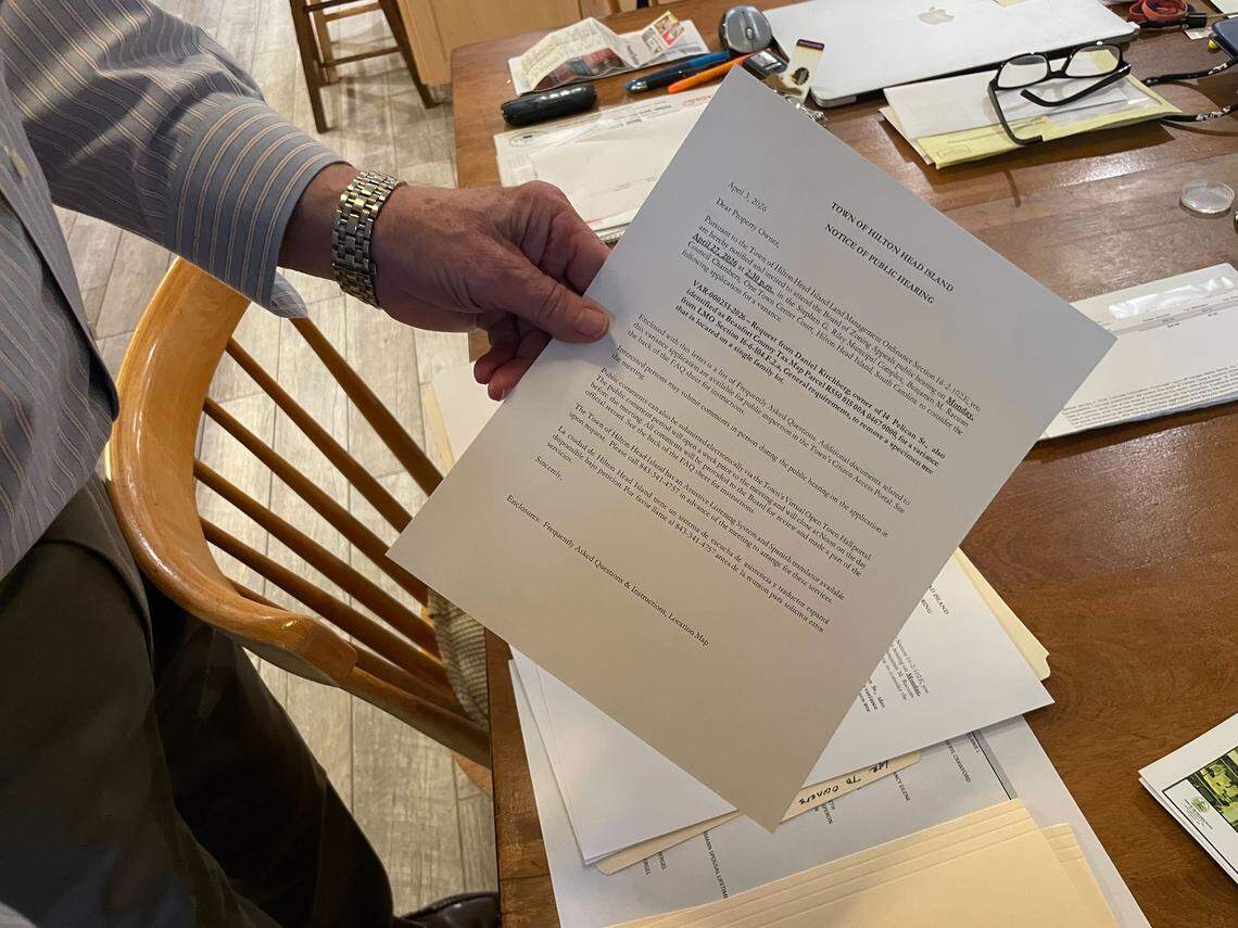 Forest Beach resident Daniel Kirchberg shows a copy of the public notice he was required to mail out to all 50 property owners within a 350-ft. radius of him.