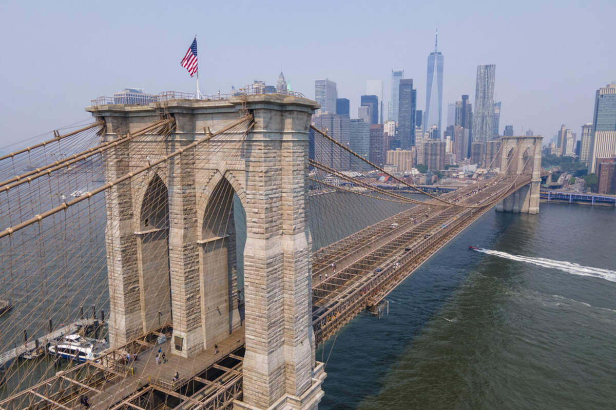 The Brooklyn Bridge, One World Trade Center and the lower Manhattan skyline are visible in New York on Thursday, June 8, 2023. With weather systems expected to hardly budge, the smoky blanket billowing across the U.S. and Canada from wildfires in Quebec and Nova Scotia should persist into Thursday and possibly the weekend. (AP Photo/Ted Shaffrey)