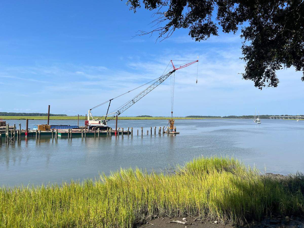 O’Quinn Marine Construction works on removing the shrimp dock on Battery Creek in Port Royal Thursday.