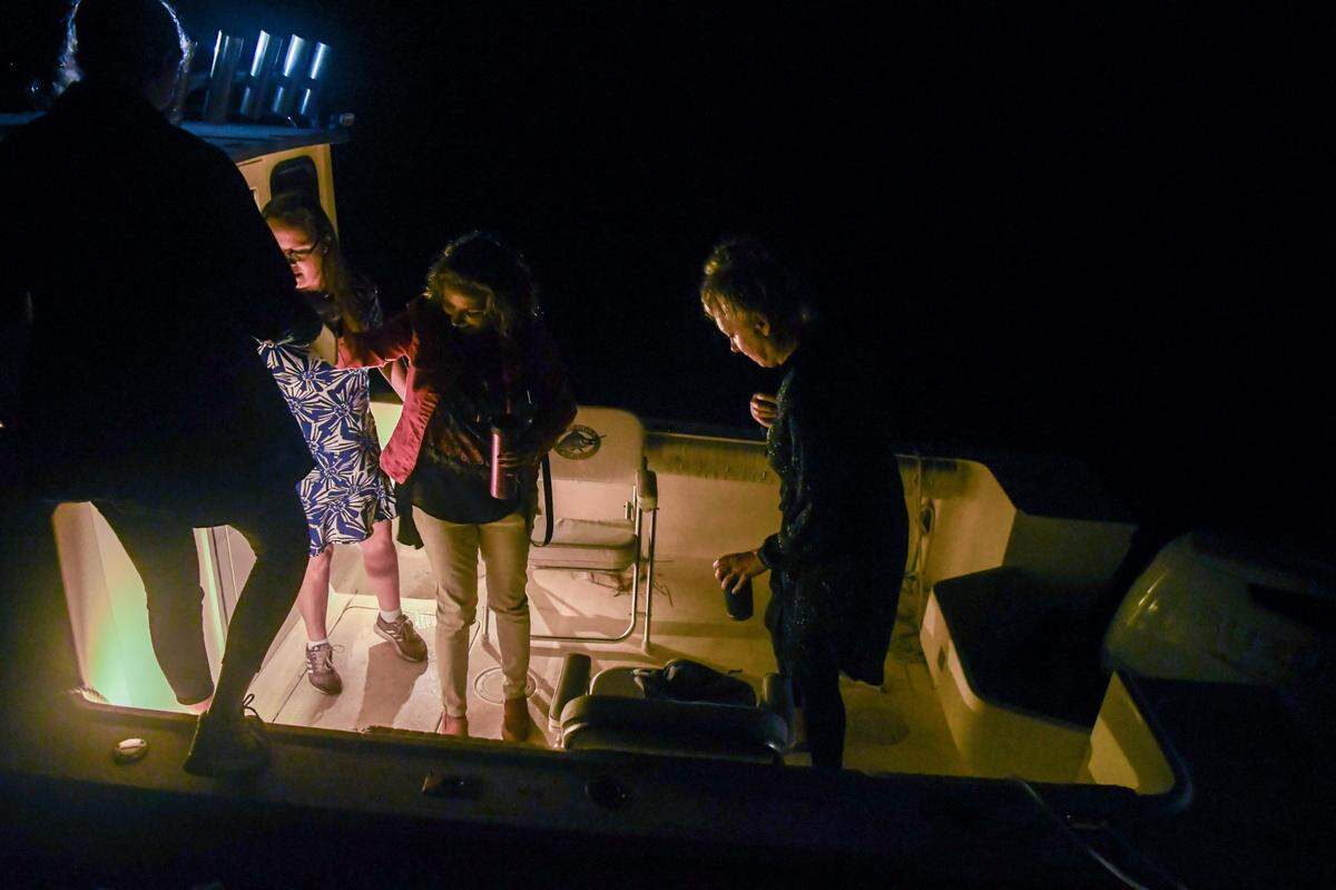 Ashley Hollingsworth, from left, Krisey Moller and Lauren Scott help an Island Packet reporter onto Hollingsworth’s boat in the early morning hours of Tuesday, Sept. 26, 2023, at Buckingham Landing on the mainland of Bluffton. The teachers use Hollingsworth boat to get from Daufuskie Island to the mainland in order to teach students on Hilton Head Island.