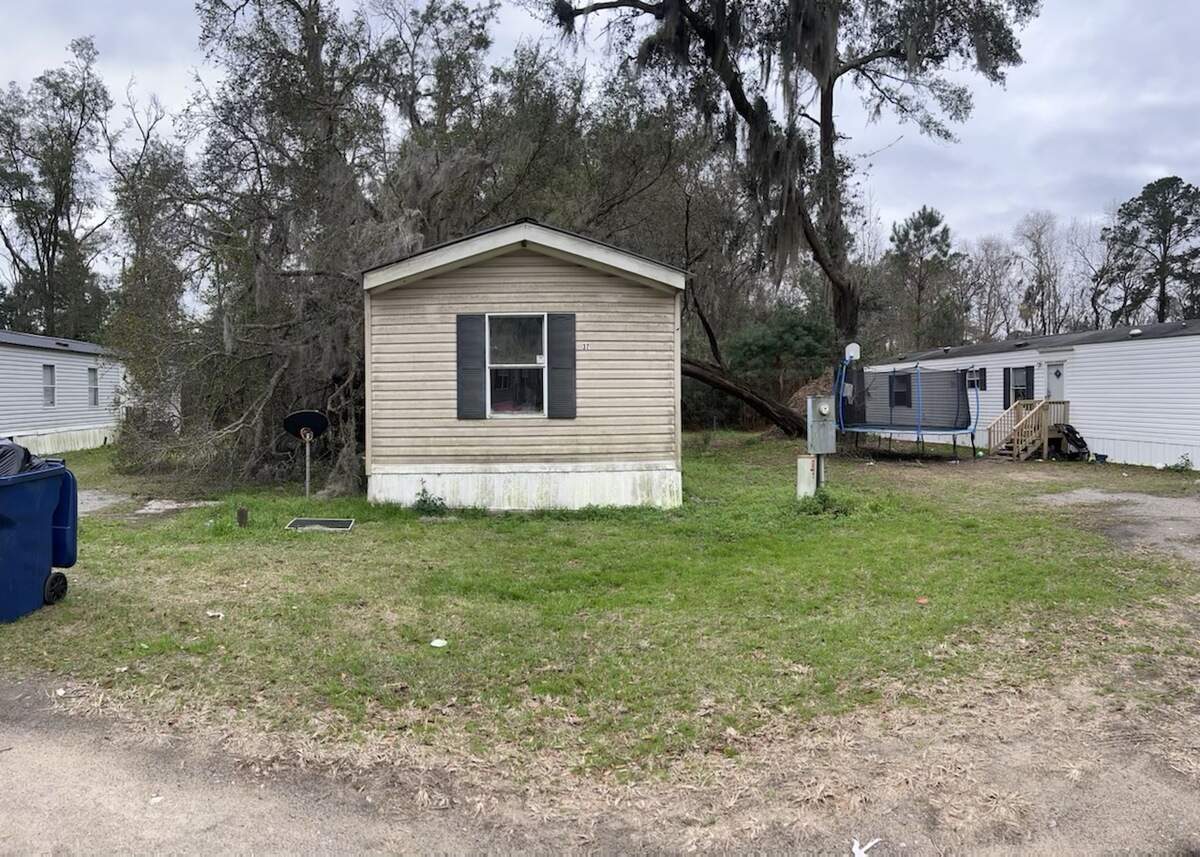 A family had to climb out of a window Monday morning after a tree blocked both the front and back door of their home, according to fire officials.
