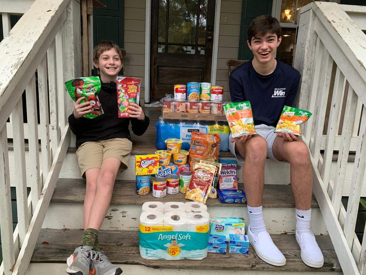 Quinn, left, and Quade Matthews pick up donations for HELP of Beaufort amid the coronavirus pandemic.