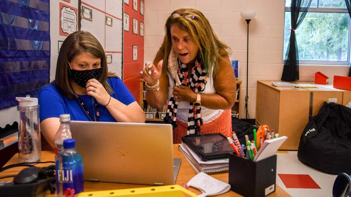 Mary Powell, left, scoots over to allow principal Brenda Blue to welcome the first graders to Pritchardville Elementary on Tuesday, Sept. 8, 2020 - the first day of school. The Beaufort County School District started the 2020-21 school year remotely due to the coronavirus pandemic.