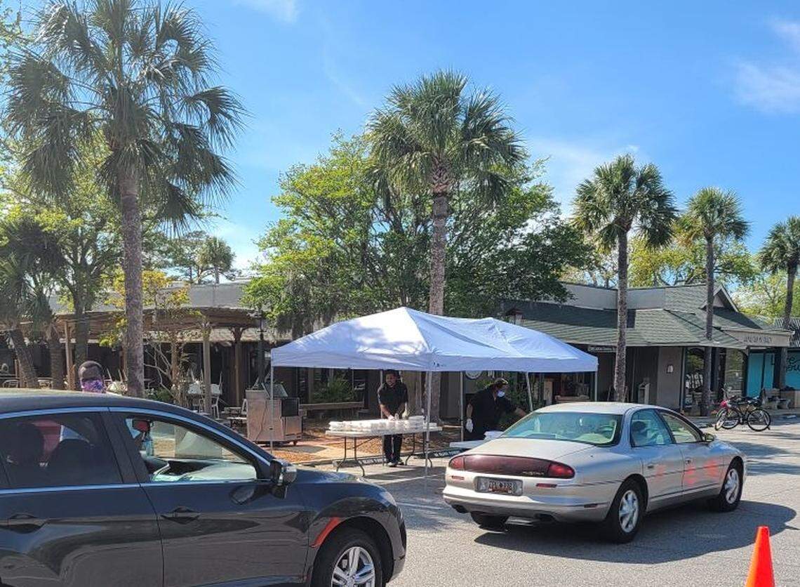 A line of cars to pick up free meals at Coligny Plaza on Hilton Head Island. FISH Coastal Casual Seafood is distributing 500 free meals each day for 2 weeks during the coronavirus.