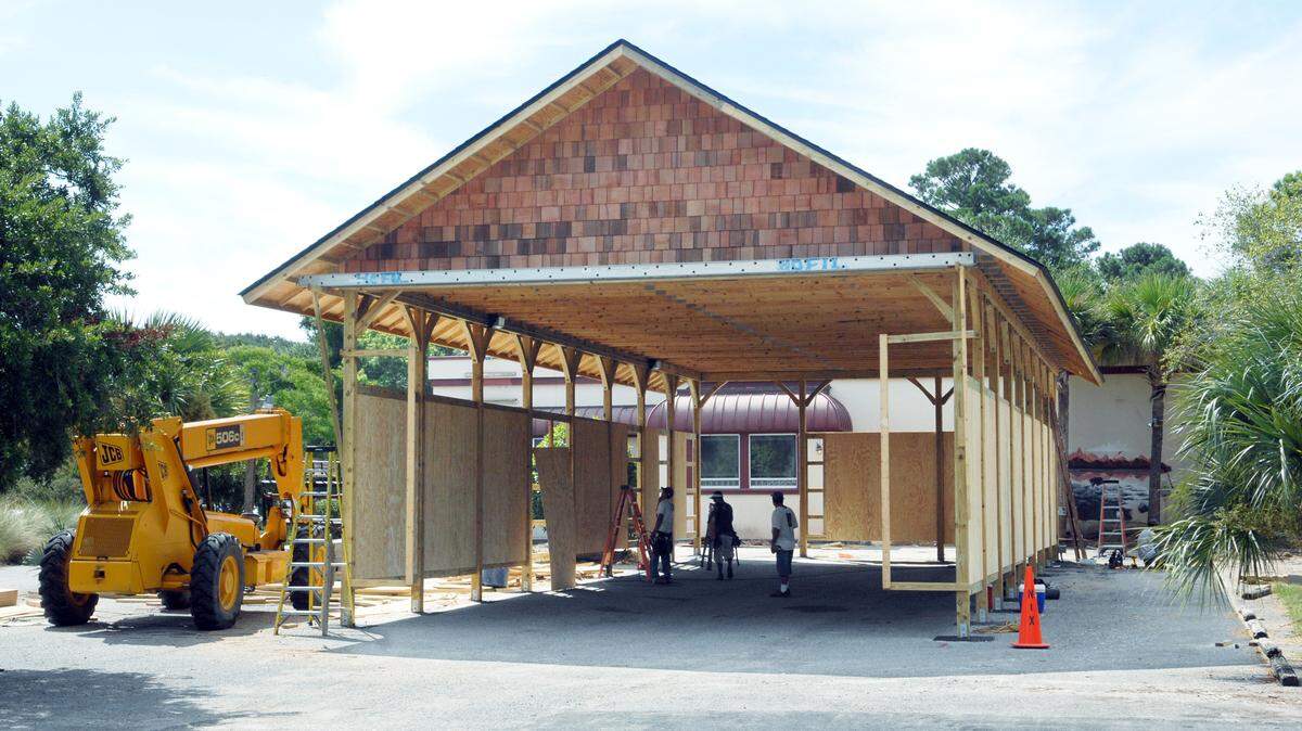 The old Smokehouse restaurant on Pope Avenue near Coligny Circle is being converted into a temporary home for Head Island Fire and Rescue Division's Station 7 at Shipyard, which is being rebuilt. Here, a wooden garage to house the station's trucks rises in the old Smokehouse parking lot. Firefighters will be housed in the former restaurant building, visible in the background.
