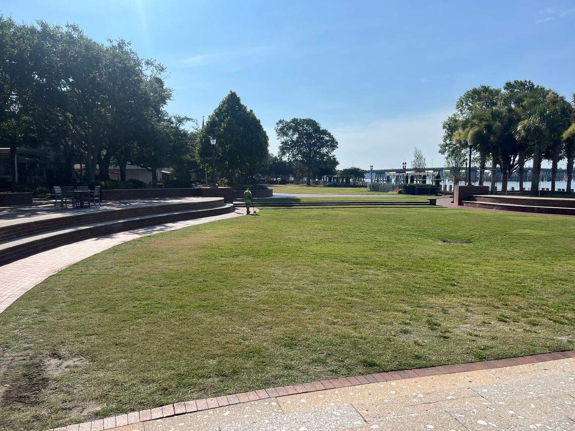 The calm before the storm: A city worker trims the grass Tuesday morning at the pavilion along the Beaufort Waterfront, where the nightly music acts perform during the 10-day Water Festival, which begins Friday.