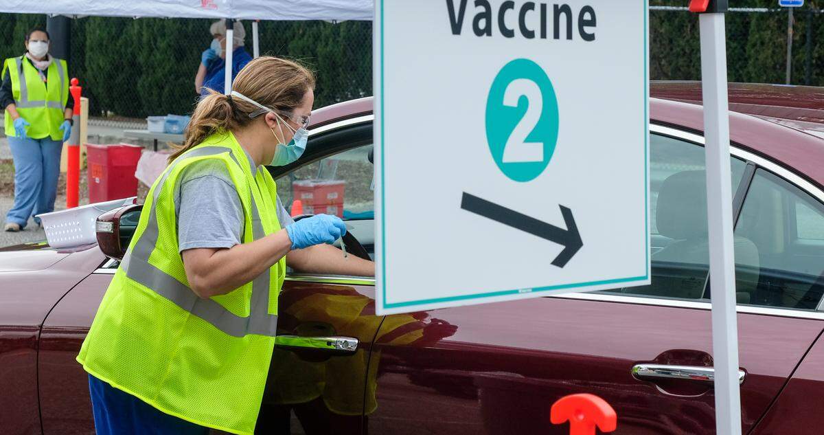 With needle in hand, Summer Cook a Registered Nurse in the emergency department at Beaufort Memorial Hospital, prepares to administer a Pfizer-BioNTech’s vaccine on Thursday, Jan. 21, 2021 in the parking lot of Beaufort High School’s stadium. Thursday marked the first drive-thru clinic for vaccine administration in Beaufort County.