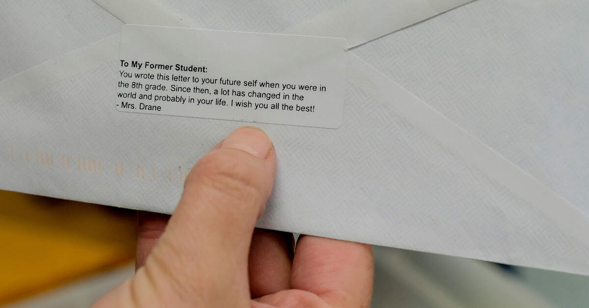 Patricia Drane, an eighth grade teacher at Hilton Head Island Middle School, shows the sticker she places on the back of letters her students write to their future selves.