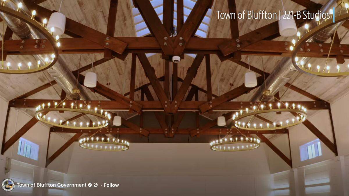 The inside of the barn features plenty of natural light and stylish chandeliers hanging form the ceiling.