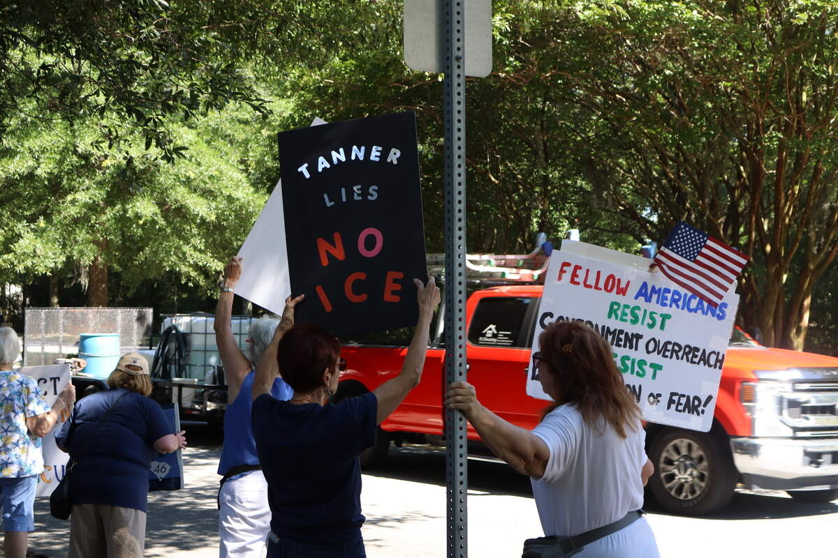 Protest attendees wave signs at drivers passing by on Bluffton Parkway on June 5, 2026, a week after residents were detained in a U.S. Immigration and Customs Enforcement operation in the Bluffton area. Many protesters criticized the Beaufort County Sheriff’s Office for taking part in the operation through their 287(g) agreement with ICE, which was signed by Sheriff P.J. Tanner in July 2025.
