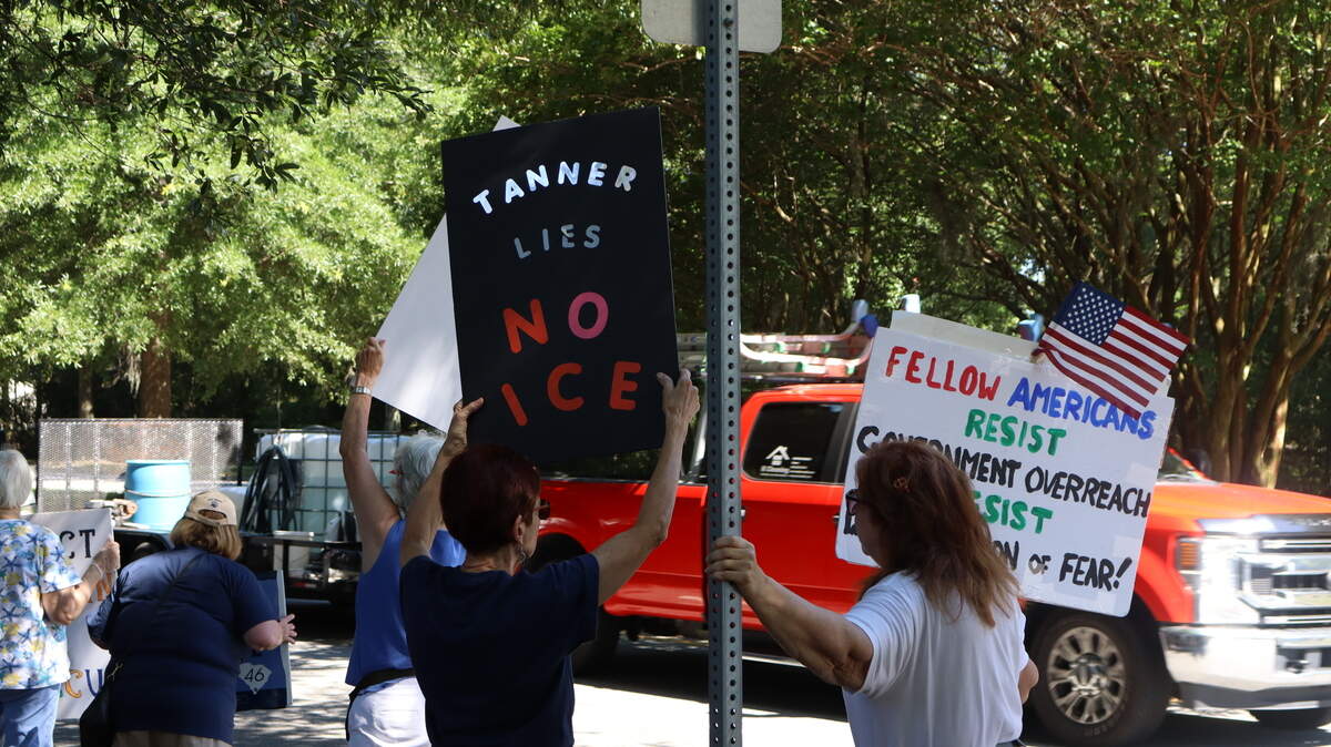 Protest attendees wave signs at drivers passing by on Bluffton Parkway on June 5, 2026, a week after residents were detained in a U.S. Immigration and Customs Enforcement operation in the Bluffton area. Many protesters criticized the Beaufort County Sheriff’s Office for taking part in the operation through their 287(g) agreement with ICE, which was signed by Sheriff P.J. Tanner in July 2025.