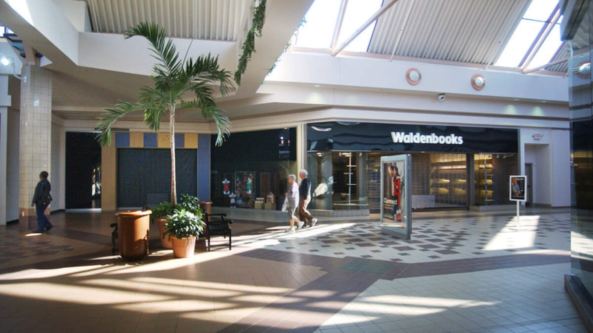 Mallgoers walk past empty storefronts, including the recently shuttered Waldenbooks location, at the Mall at Shelter Cove on Wednesday.