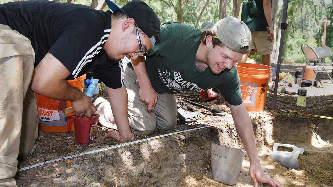 Recent Binghamton University graduate Wei Hao Ng, left, and student Mark Richter, work Monday on an archaeological dig at the Mitchelville Freedom Park. The dig, commissioned by the Mitchelville Preservation Project, is searching for the location of a praise house from the 1860s that is thought to be in the park. The preservation project hopes to one day build a replica of the praise house there. Katie Seeber, a Binghamton University graduate student leading the dig, said she thought they were getting close to finding the praise house site, but that it might take as long as a year before they know for sure.