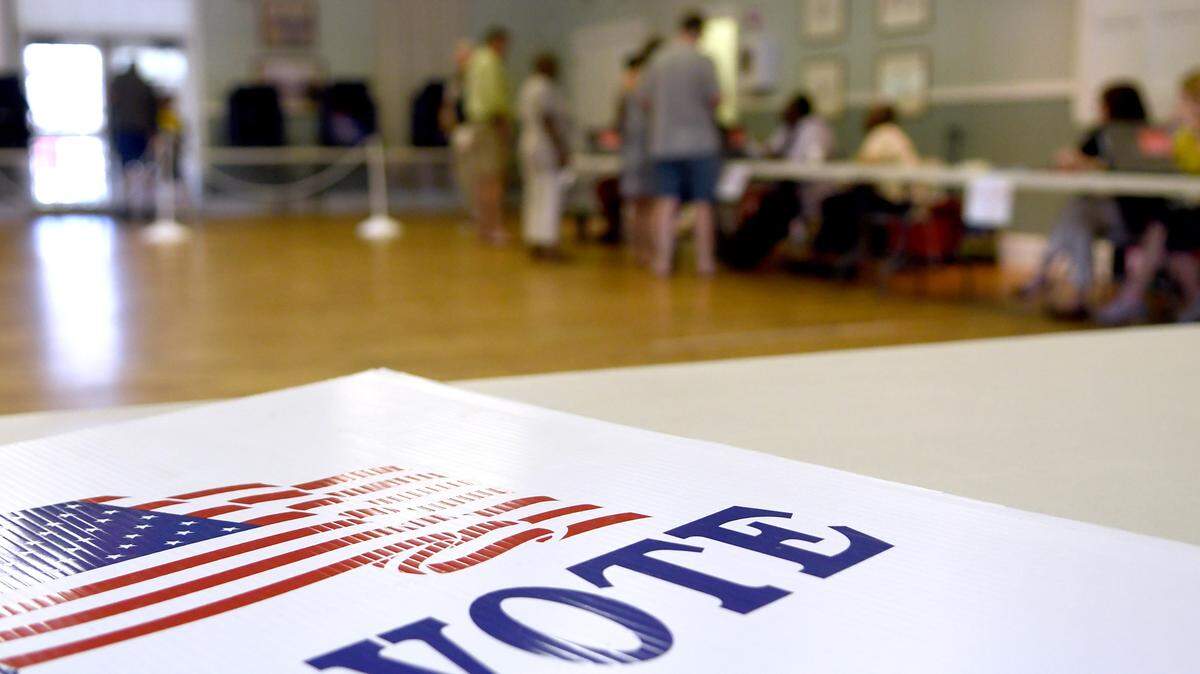 A “Vote” poster lies on the table at The Rotary Community Center at Oscar Frazier Community Park polling location located on Recreation Court on Tuesday morning as voters and poll workers approached the polling table.