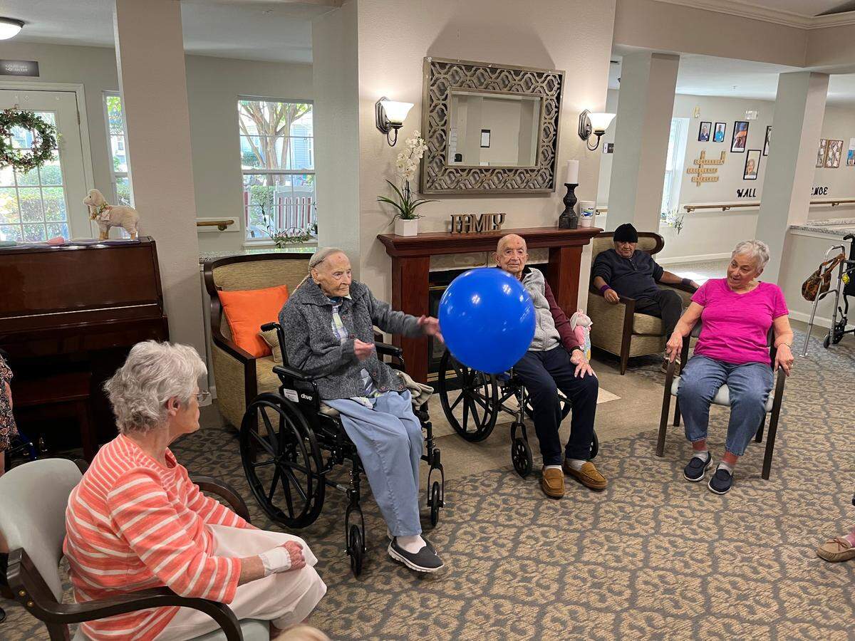 Eutelle Nix keeps a ball in play at the Helena Place Senior Living in Port Royal earlier this week as residents, including Bill Stultz, immediately to her right, participate in morning exercise. Nix will be 110 Friday. Stultz will be 103 Tuesday.