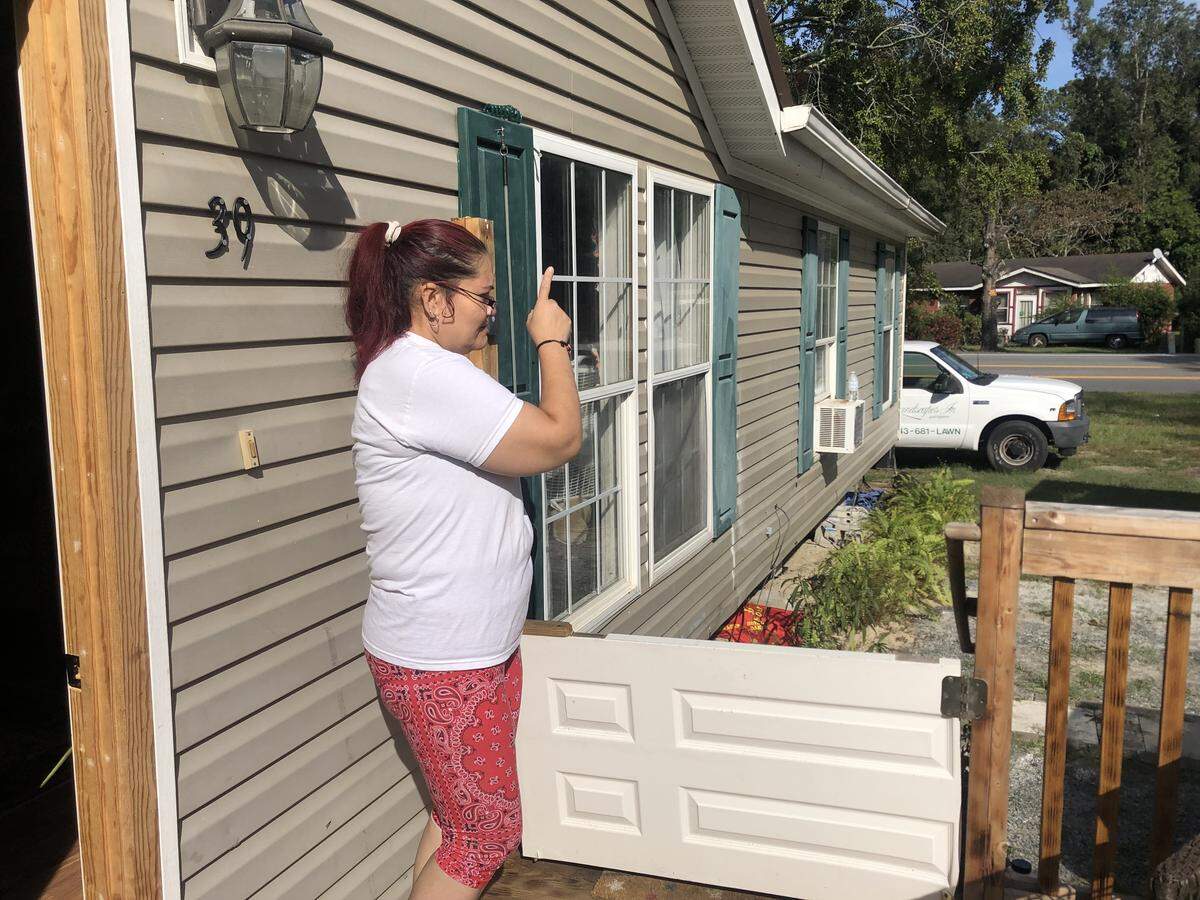 Jeannette Galvez-Martinez stands in front of her new home on Gum Tree Road. It cost around $12,000 to move her trailer from Spanish Grove Trailer Park.