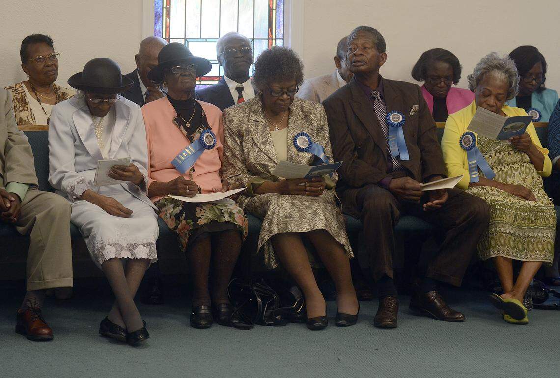 Several of the former students of Cherry Hill School listen to speakers during the presentation before the unveiling of the South Carolina historical marker for the school Sept. 20, 2013 at the school on Hilton Head Island.