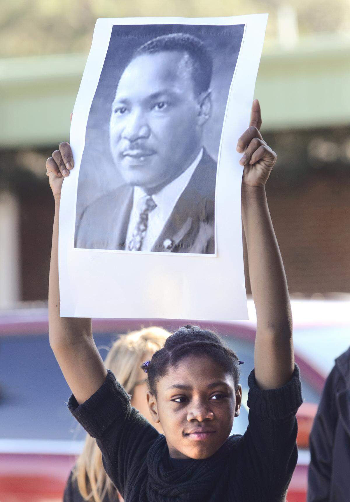 In this 2016 file photo, Daysha Green of Yemassee carries a portrait of Dr. Martin Luther King Jr., during the annual Martin Luther King Jr. Day memorial walk and parade through Old Town Bluffton.
