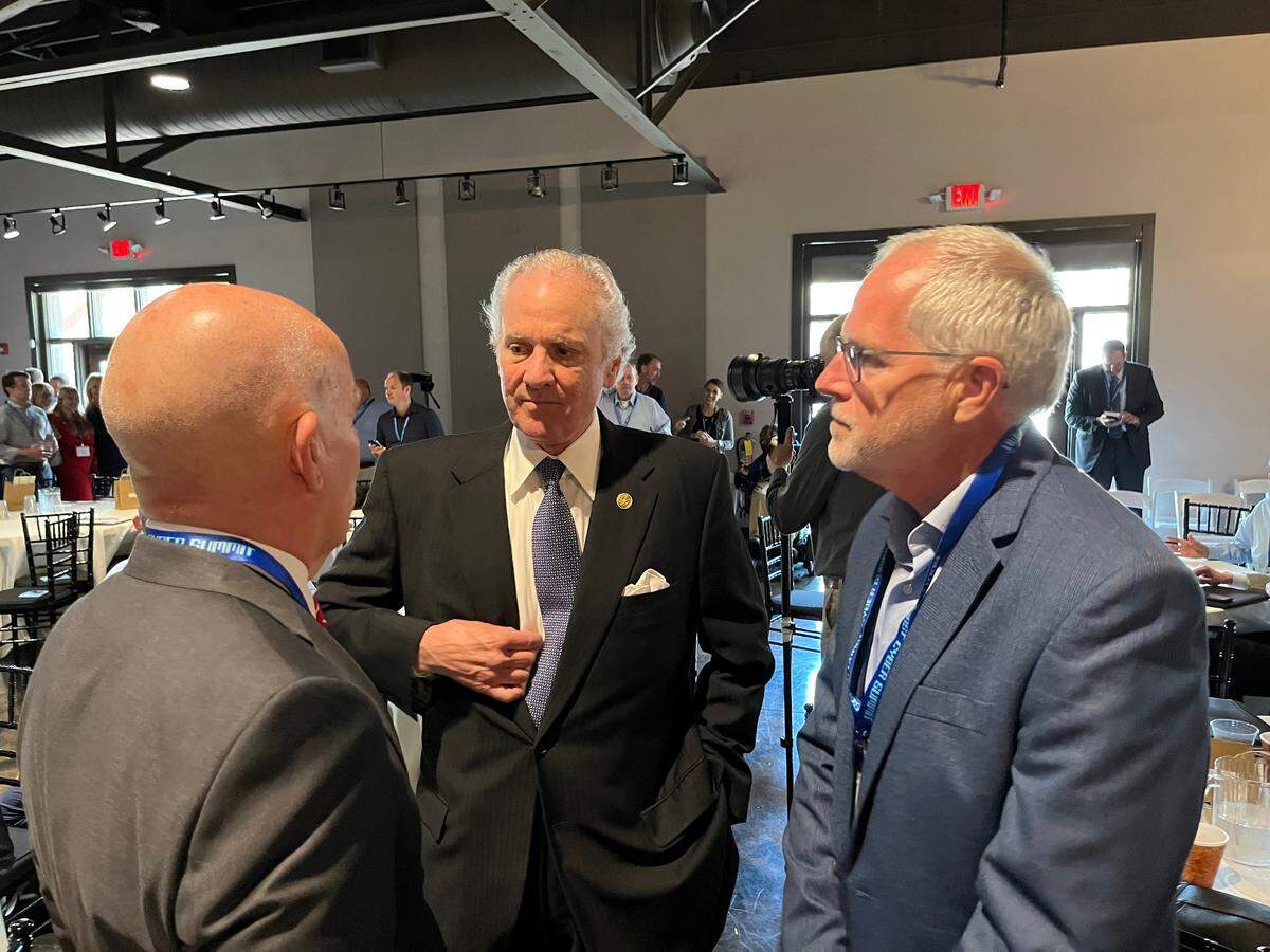 Gov. Henry McMaster, center, speaks with Warren Parker and Rick Siebenaler of the South Coast Cybersecurity Center.