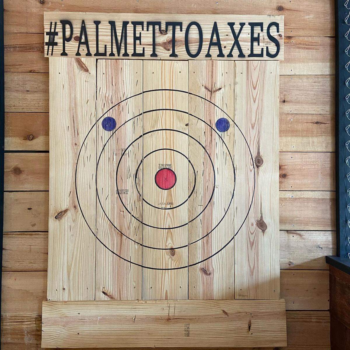 Coaches work with customers to learn to hit the bull’s-eye at Palmetto Axes.